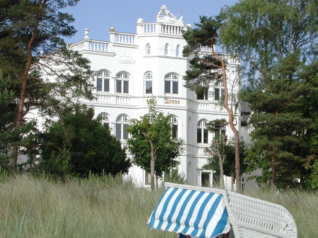 a bench in front of a white building at Villa Sirene Whg 4 Königsstuhl - 5 Sterne in Binz