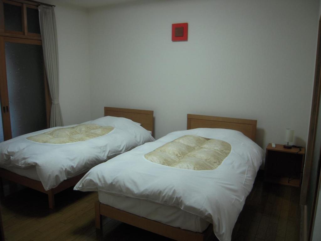 Postel nebo postele na pokoji v ubytování Nakaya House
