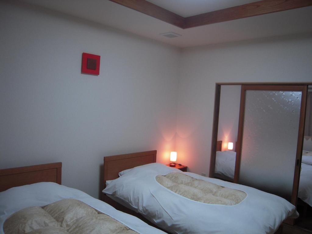 Postel nebo postele na pokoji v ubytování Nakaya House
