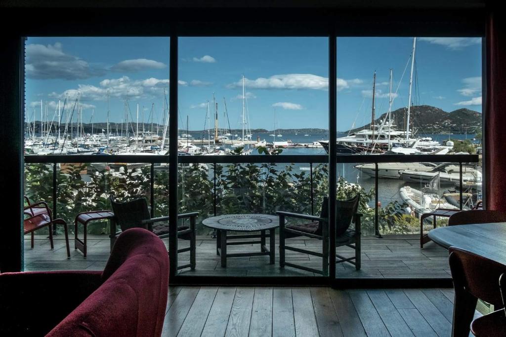 a patio with a view of a marina with boats at Immeuble La Mer in Porto-Vecchio