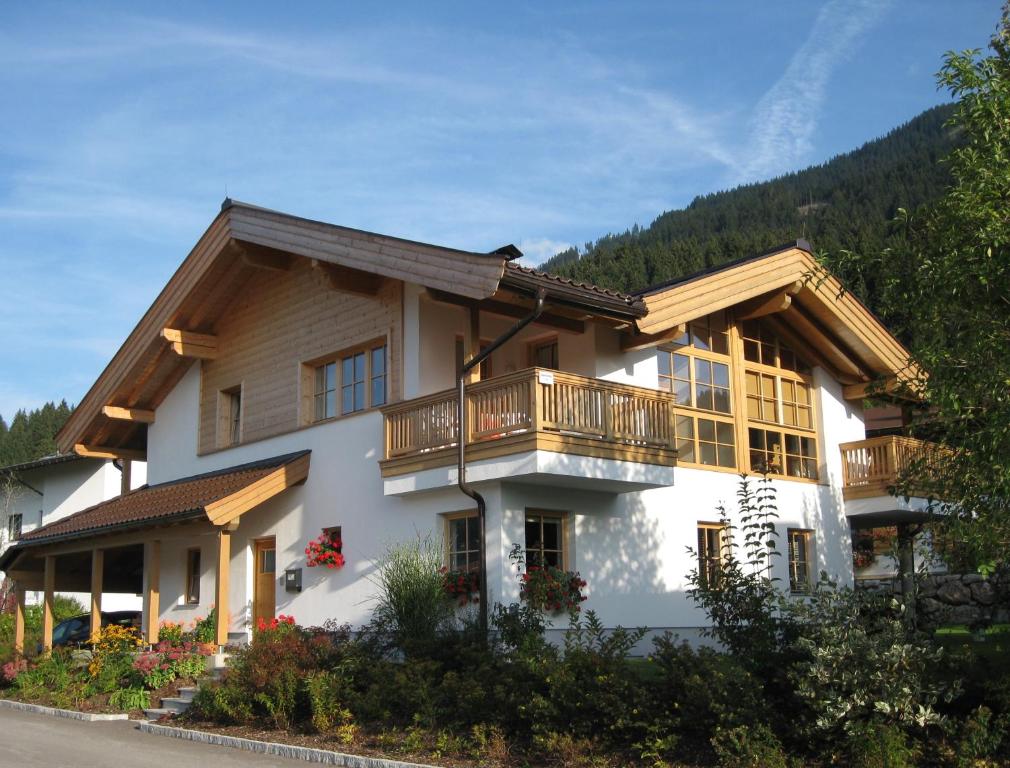 a house with a balcony on the side of it at Chalet Isabella in Westendorf