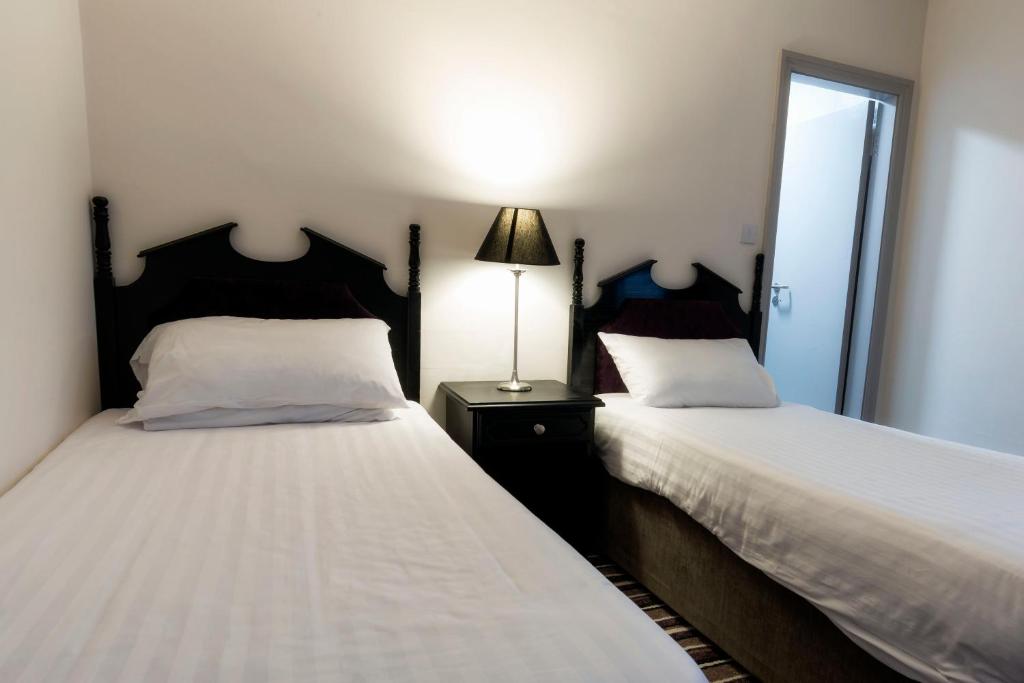 Postel nebo postele na pokoji v ubytování Ivy Tower Hotel