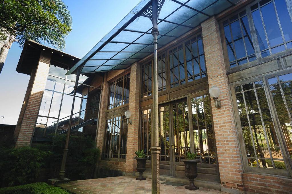 a large brick building with windows and a pole at Locanda Buona Fortuna in Cotia