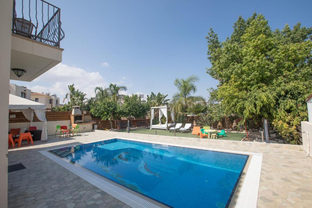a swimming pool in a resort with a playground at Artemisia Villa in Protaras