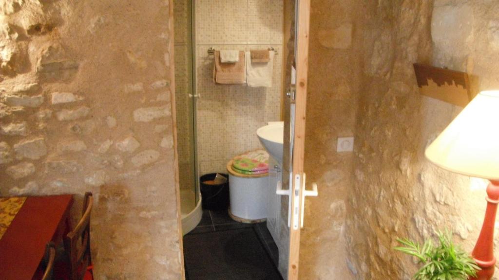 a small bathroom with a toilet and a sink at La Maison Rouge in Chauvigny