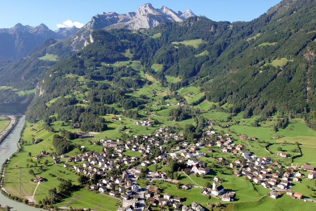 an aerial view of a village in the mountains at Hotel Krone in Attinghausen