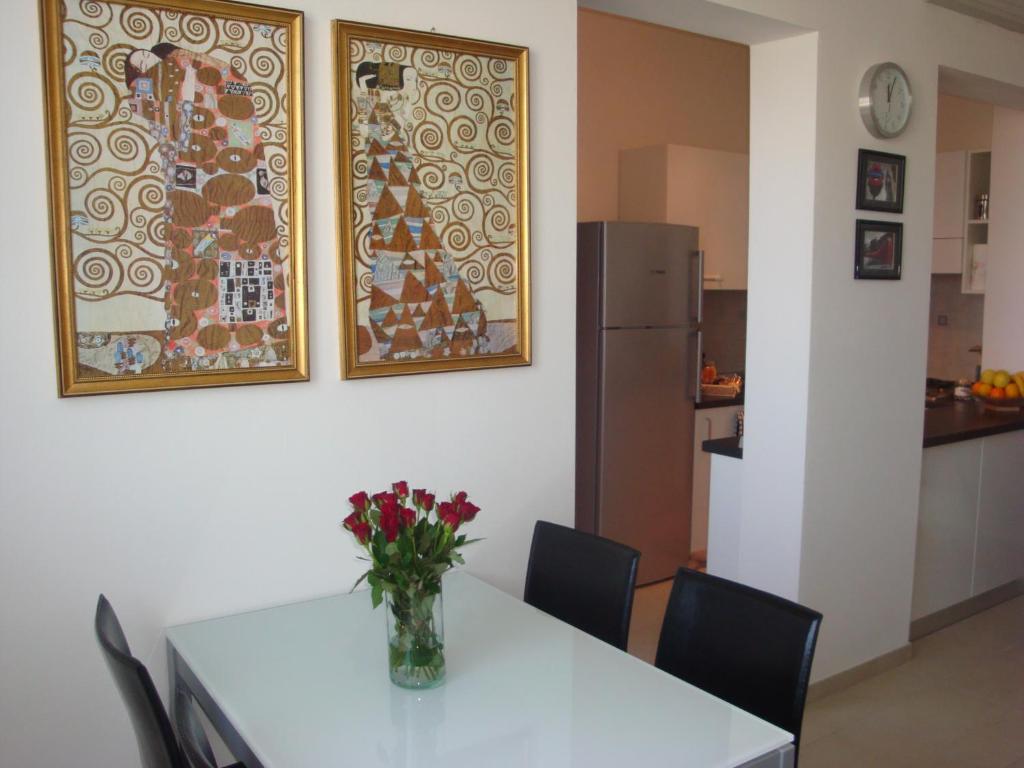 a dining room table with a vase of flowers on it at Alloggio al Naviglio in Copparo