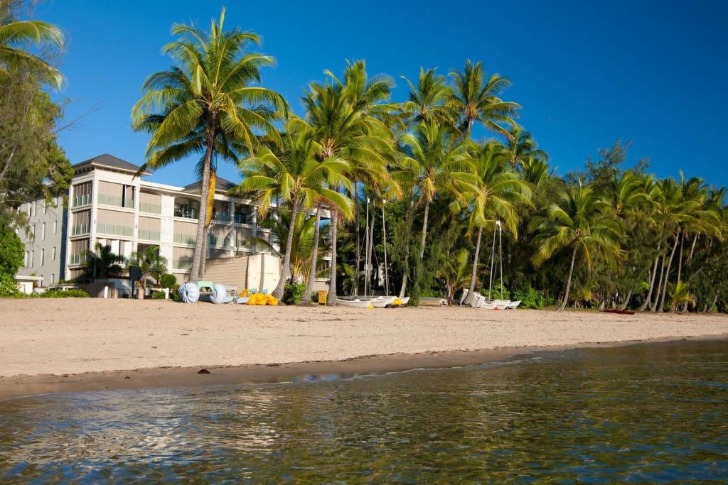 a house on the beach with palm trees at Island Views Beachfront Apartments in Palm Cove