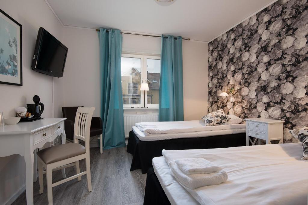 Postel nebo postele na pokoji v ubytování Bjurfors Hotell & Konferens