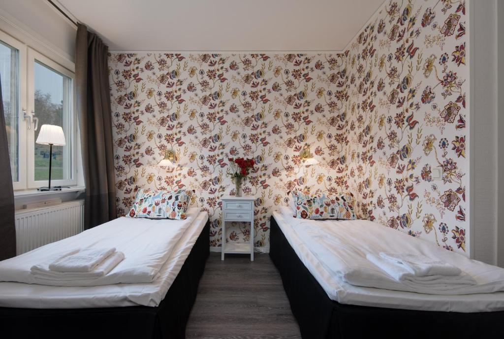 Postel nebo postele na pokoji v ubytování Bjurfors Hotell & Konferens