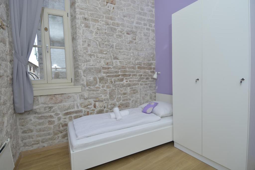 Postel nebo postele na pokoji v ubytování Hostel Sv. Lovre