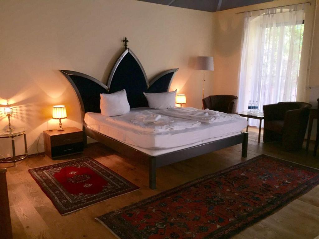 a bedroom with a large bed with a large headboard at Pension Tempelhof in Berlin
