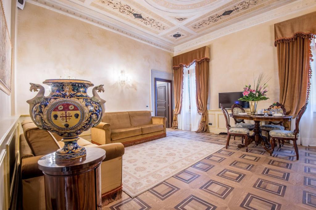 a living room with a couch and a table at Hotel Nani Mocenigo Palace in Venice