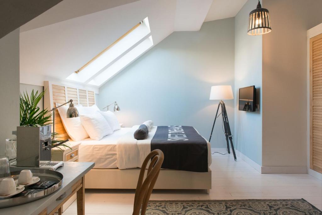a bedroom with a bed and a dining table at Smokvica Dorćol B&B in Belgrade