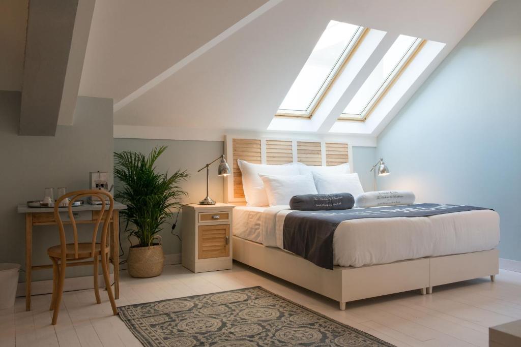 a bedroom with a bed and a skylight at Smokvica Dorćol B&B in Belgrade