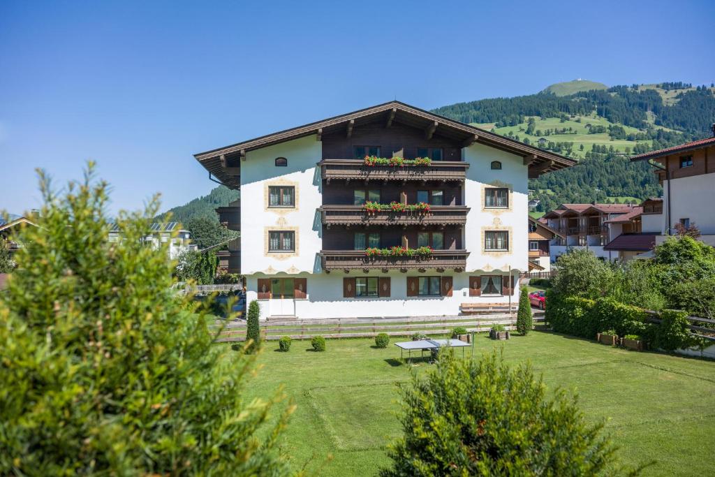 a large apartment building with a green yard at Haus Carolin in Westendorf