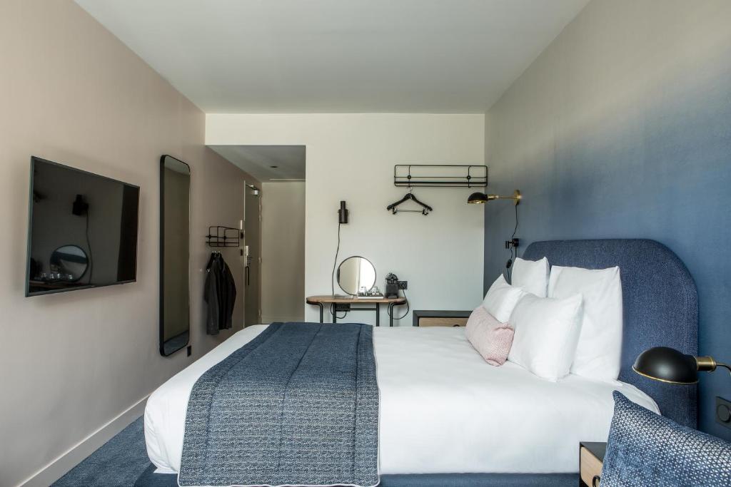 Ένα ή περισσότερα κρεβάτια σε δωμάτιο στο L'Imprimerie Hôtel