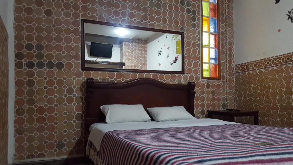 Ένα ή περισσότερα κρεβάτια σε δωμάτιο στο Hostal Balcony