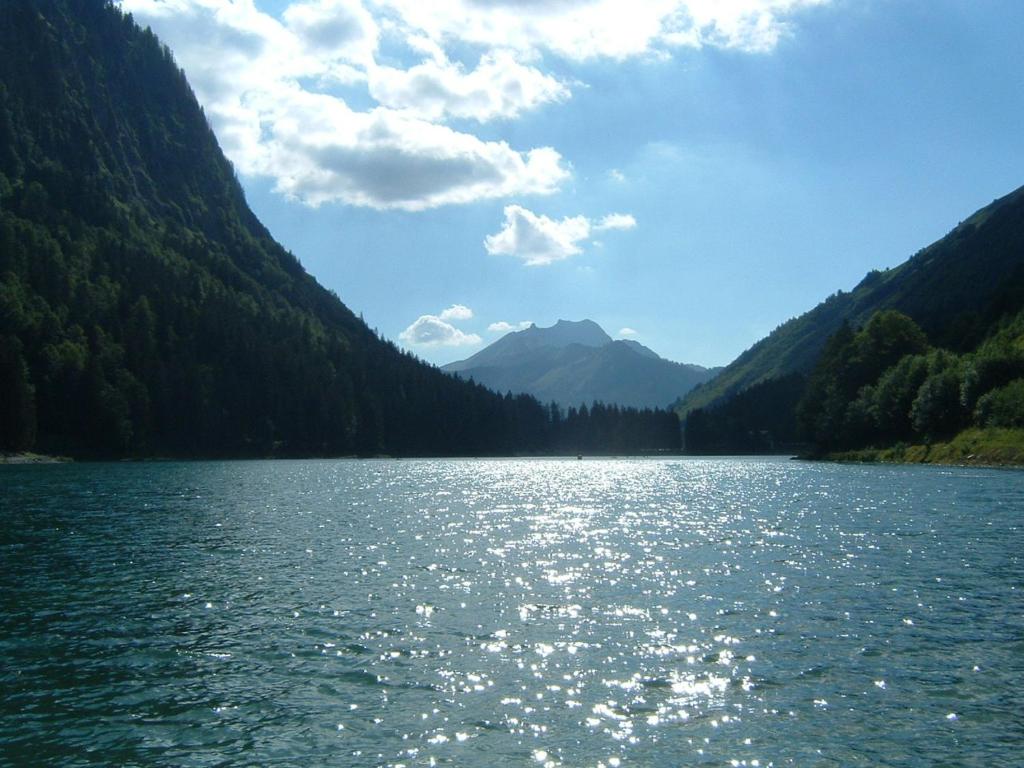 a body of water with mountains in the background at Chalet Leslie in Morzine
