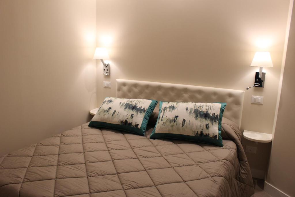 Postel nebo postele na pokoji v ubytování CASA GRAMSCI B&B