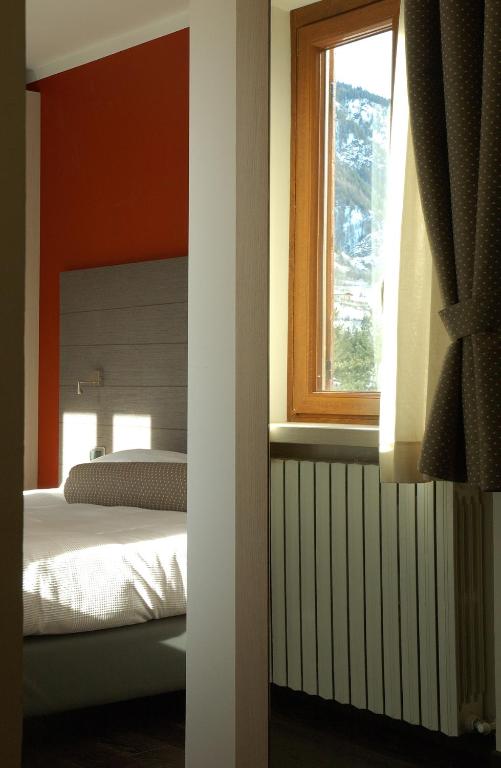 Postel nebo postele na pokoji v ubytování Hotel Bucaneve