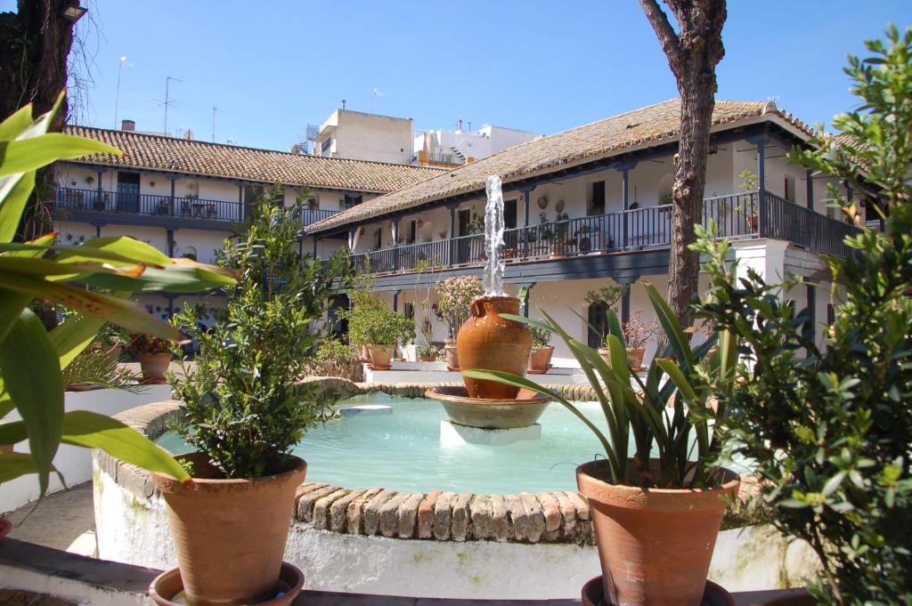 a courtyard with a fountain in front of a building at Luxury Apartment Plus Ultra in Seville