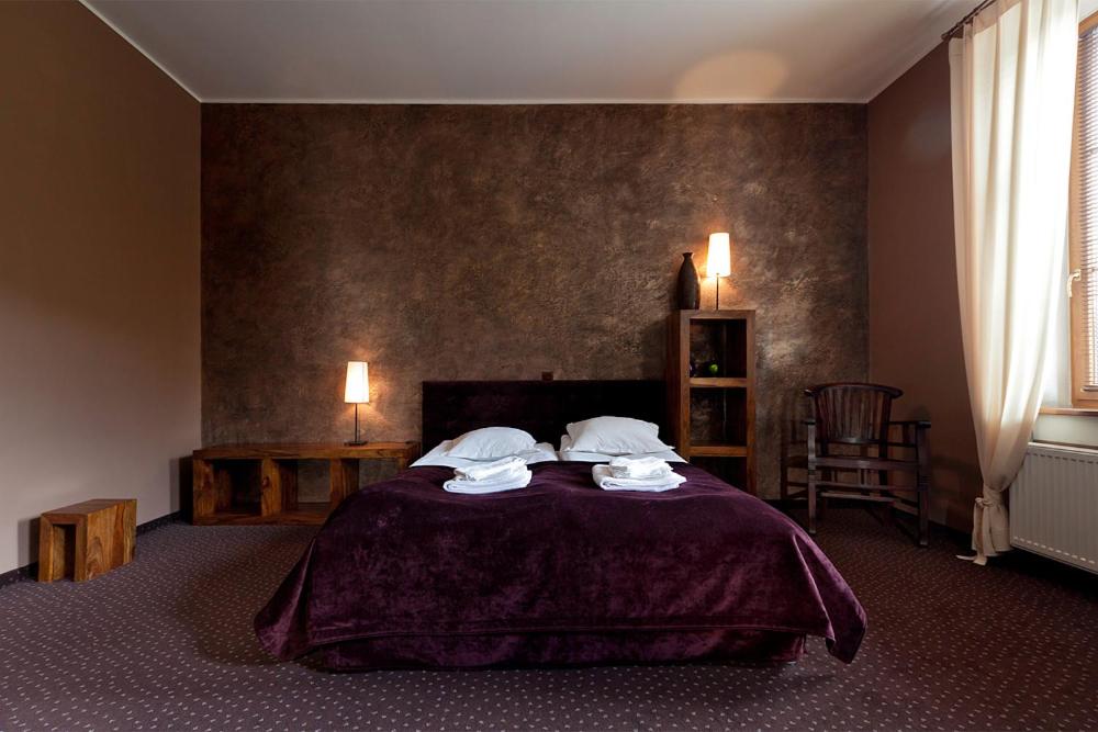 瓦烏布日赫的住宿－阿普羅波斯餐廳俱樂部酒店，一间卧室配有一张床,上面有两条毛巾