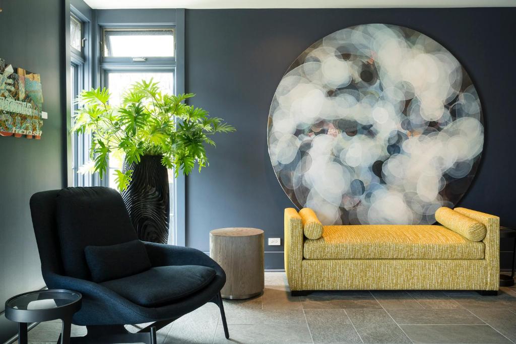 a living room with a couch and a chair at Hotel Arts Kensington in Calgary