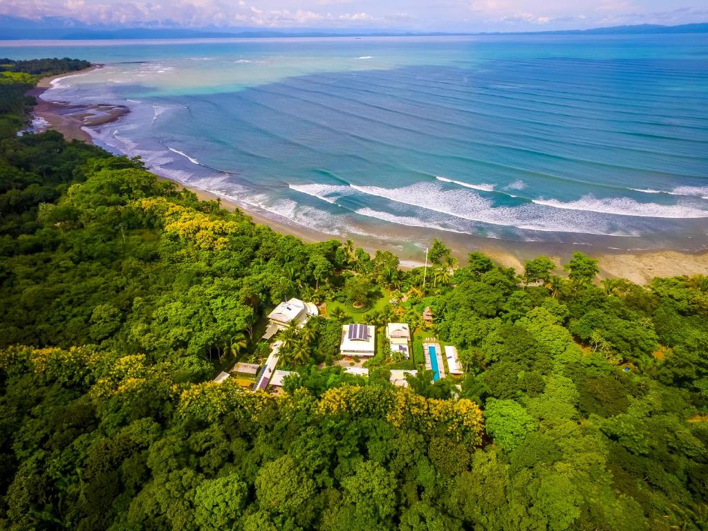 an aerial view of a beach and the ocean at Blue Osa Beach Resort & Spa in Puerto Jiménez