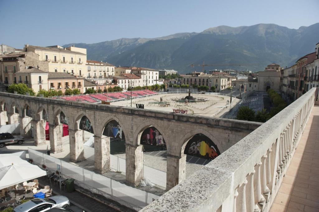 un vieux pont en pierre sur une ville avec des bâtiments dans l'établissement B&B Sei Stelle, à Sulmona