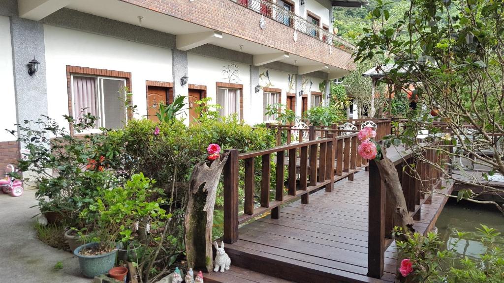 a wooden walkway in front of a house at Yi Jia Yuan Homestay in Nanzhuang