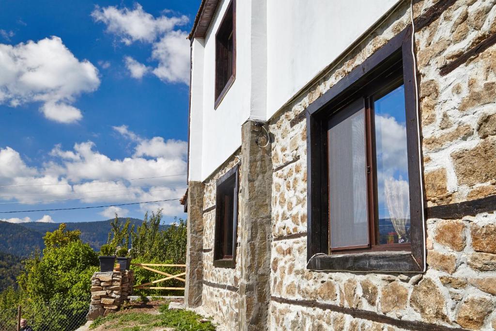 a stone house with a window on the side of it at Guesthouse Vazrozhdenski kashti in Manastir