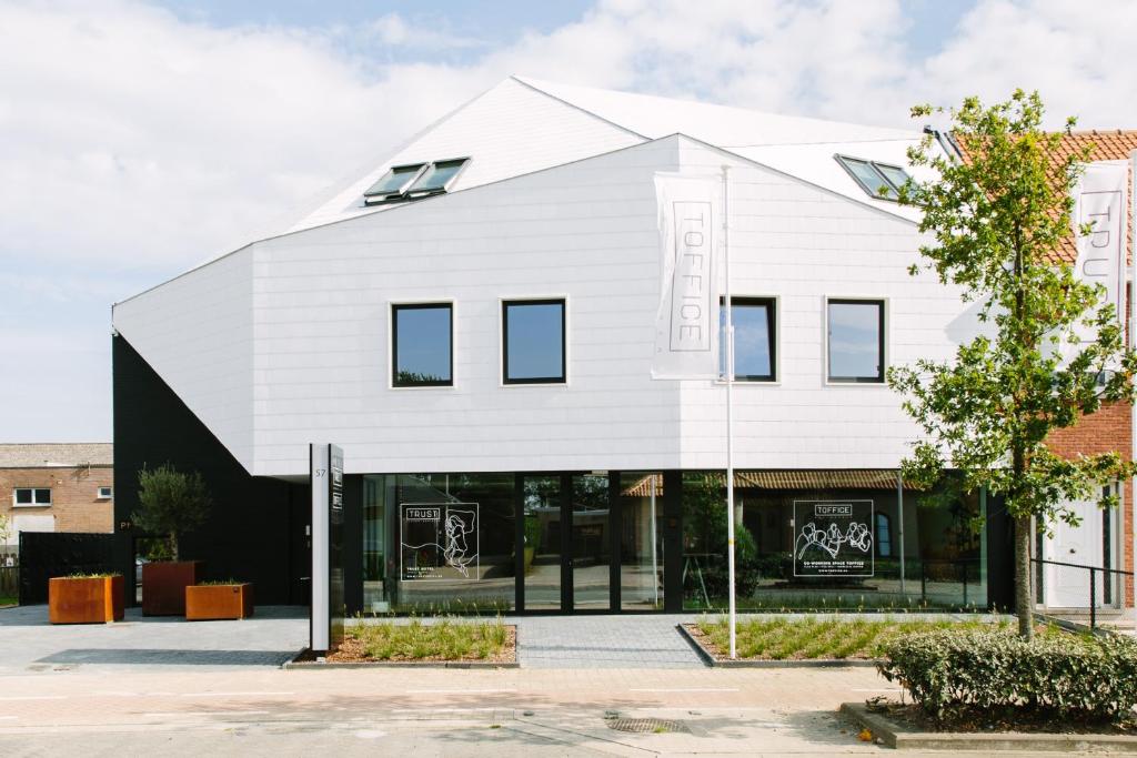 a white building with a black facade at TRUST Hotel in Beveren