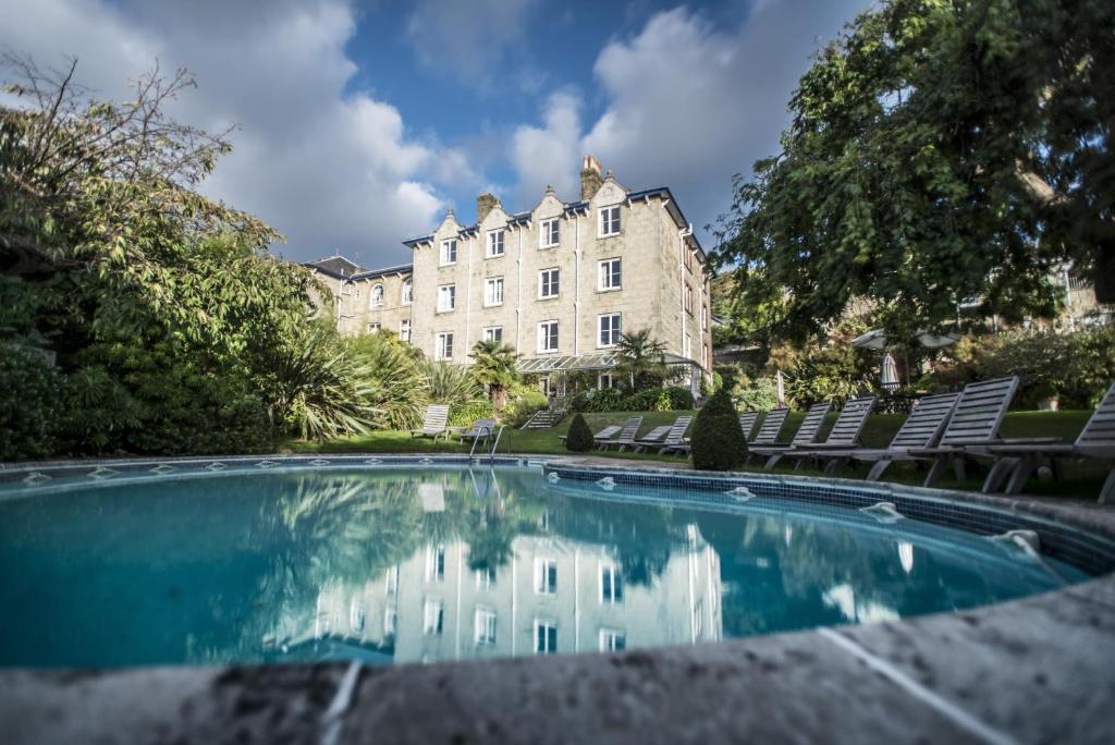 a swimming pool in front of a large building at The Royal Hotel in Ventnor