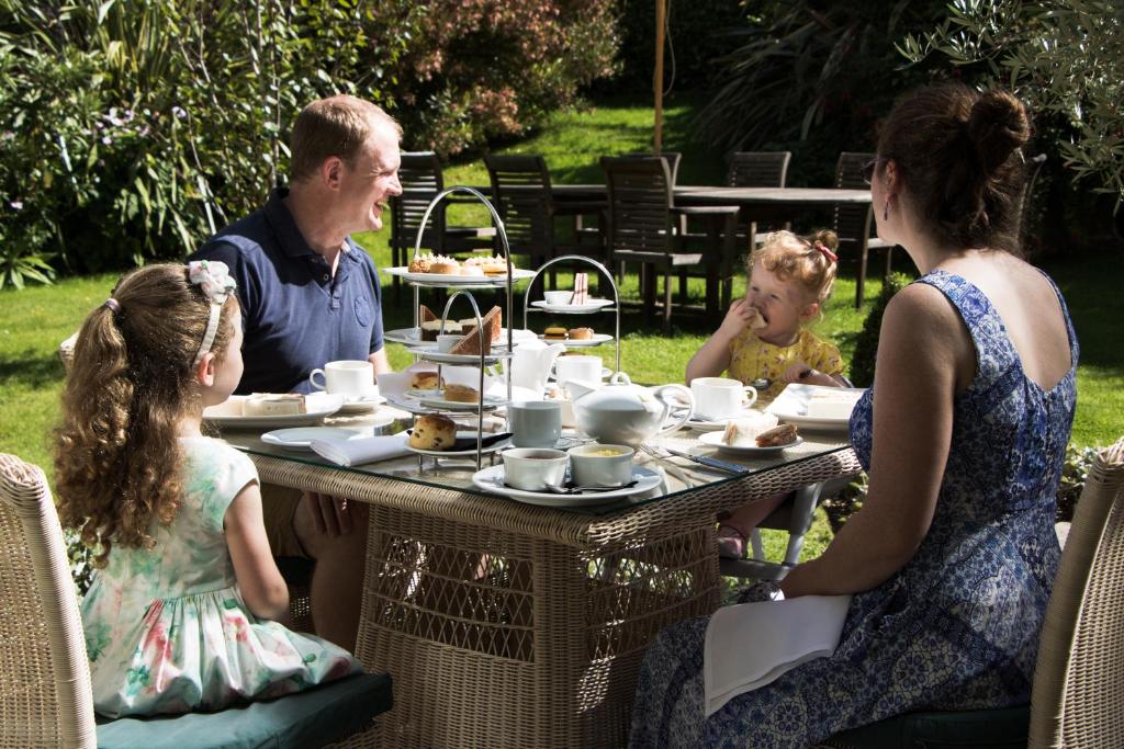 a family sitting at a table eating food at The Royal Hotel in Ventnor