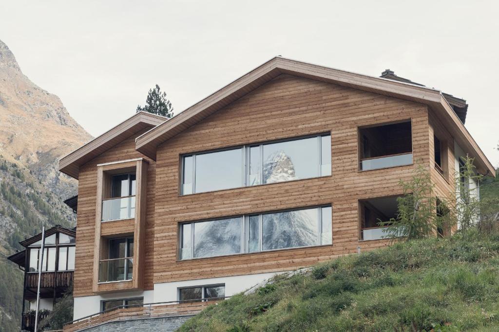 a house on top of a hill at OVERLOOK Lodge by CERVO Zermatt in Zermatt