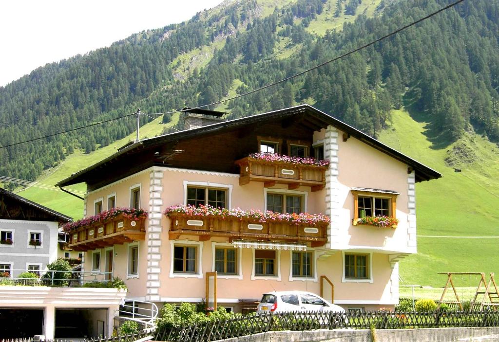 a building with flower boxes on the front of it at Haus Staud in Schmirn