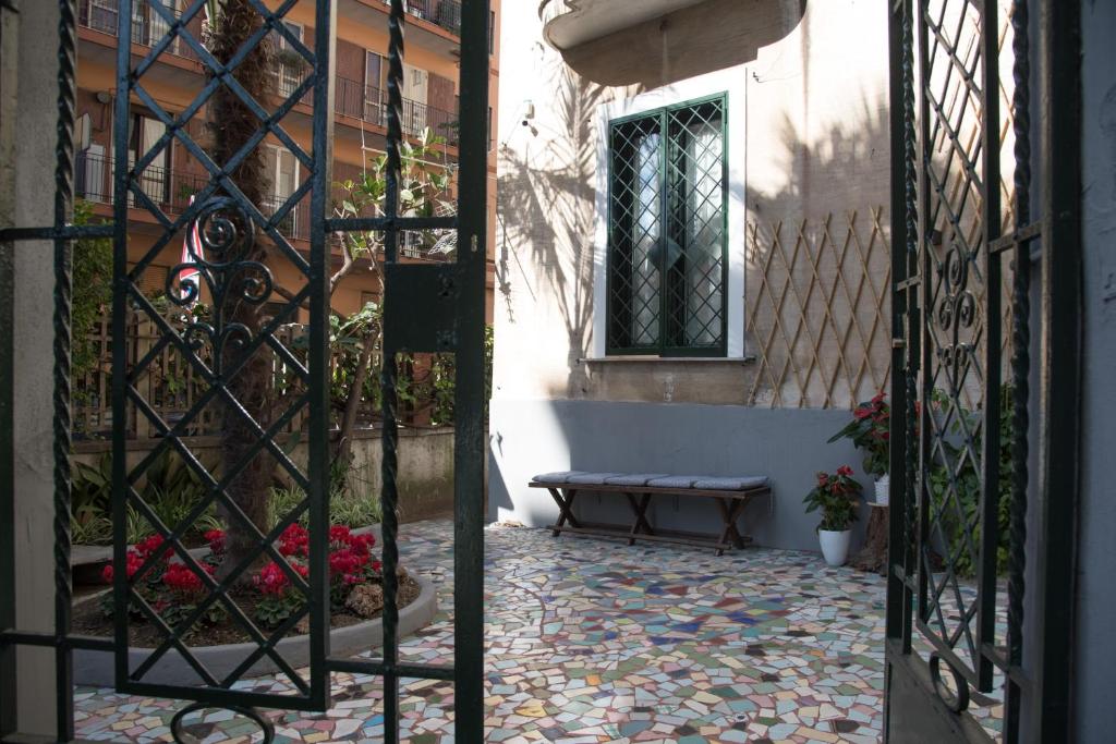 an open gate with a bench in front of a building at Villino Teresa in Salerno