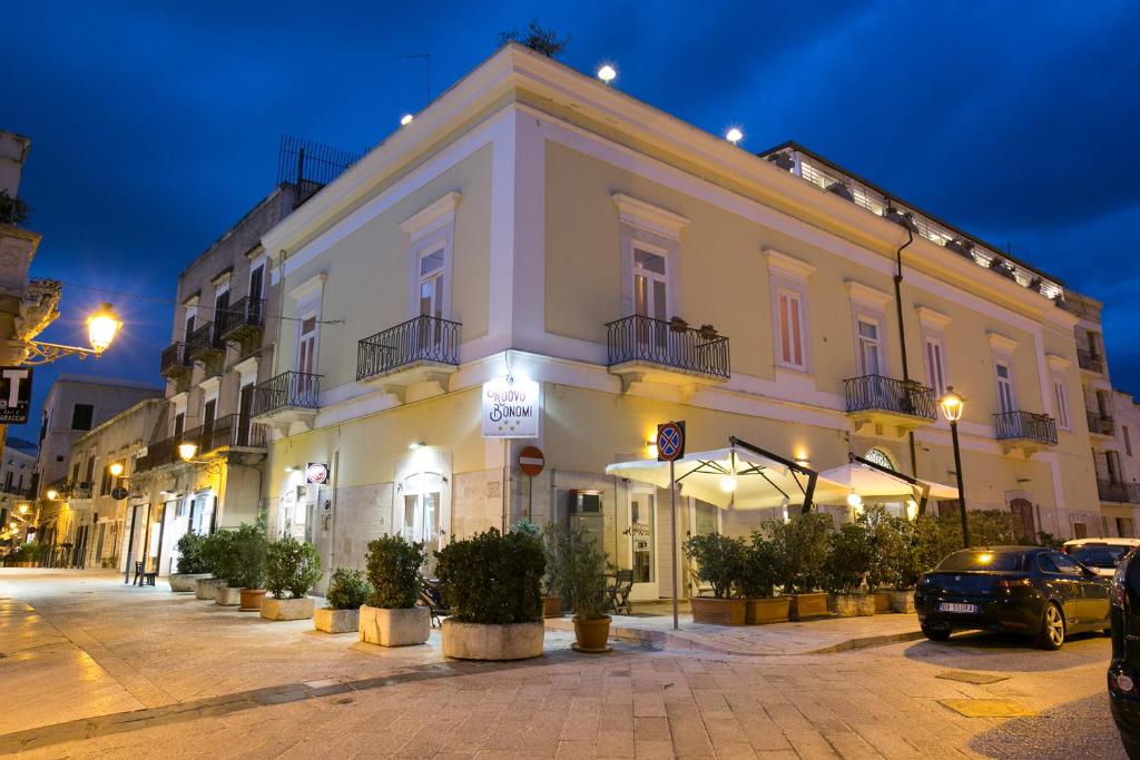 a large white building on a street at night at Palazzo Bonomi in Bisceglie