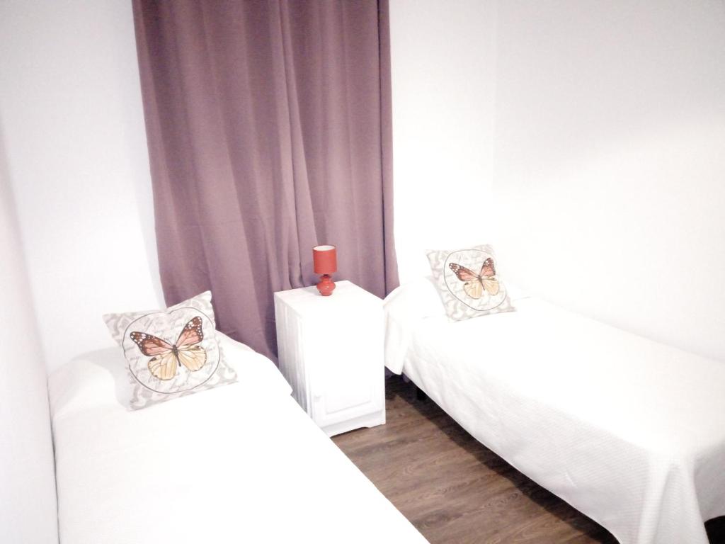 A bed or beds in a room at Apartamentos La Concepción