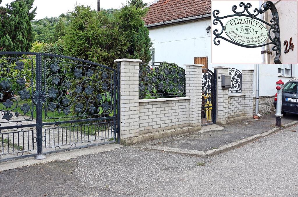 a wrought iron gate in front of a building at Elizabeth Apartman in Tokaj