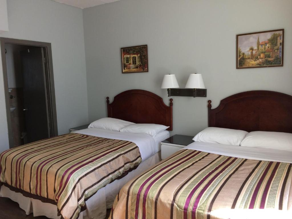 Postel nebo postele na pokoji v ubytování Hotel Bon Accueil