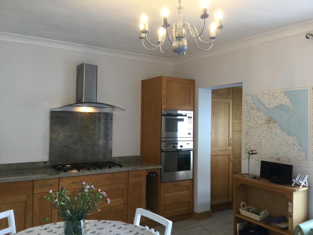 a kitchen with a table and a stove top oven at Seascape in Cleethorpes