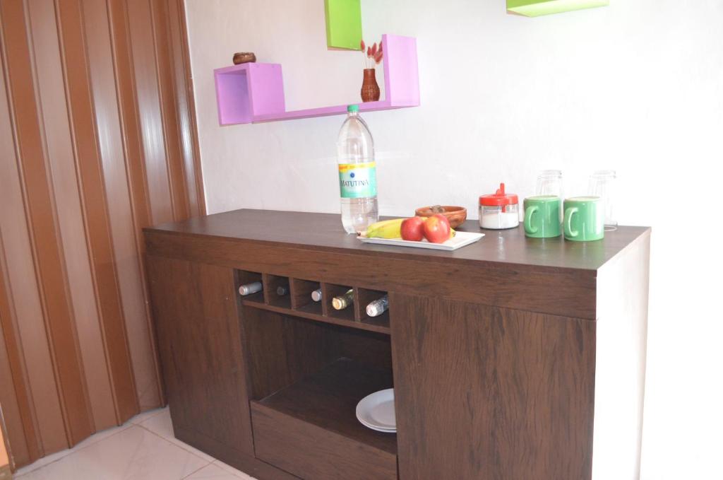 a table with a bottle of water and fruit on it at Casa La Norma in Nueva Palmira