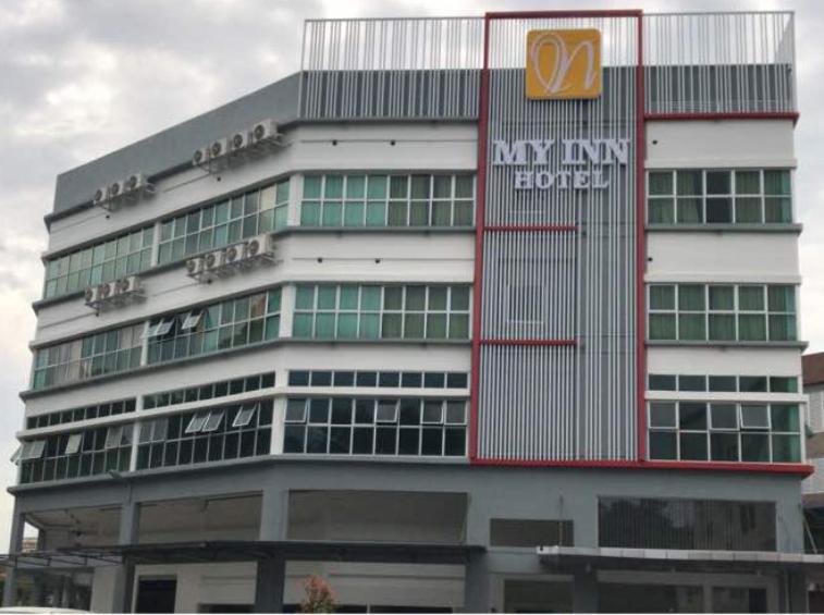 a building with a sign on the side of it at My Inn Hotel Kota Samarahan in Kota Samarahan