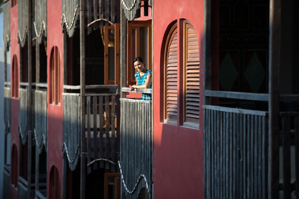 a person sitting at a window of a train at Amnaya Resort Kuta in Kuta