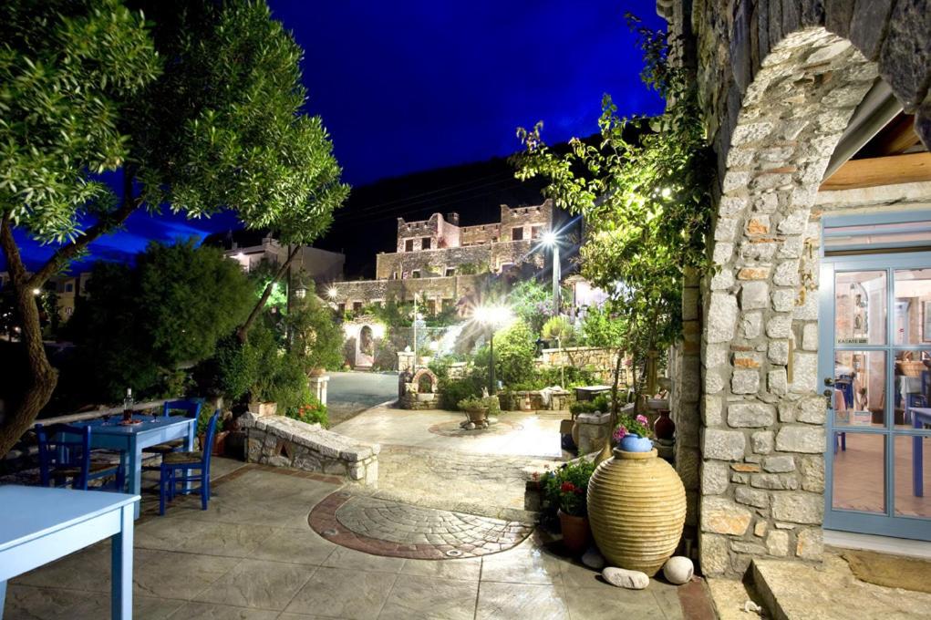 a large vase sitting next to a building at night at Elixirion Guest House in Karavostasion