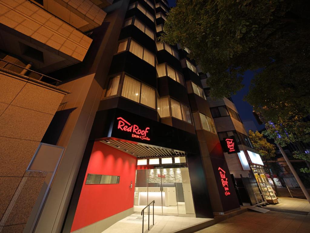 a hotel building with a red door in front of it at Red Roof Inn & Suites Osaka Namba Nipponbashi in Osaka