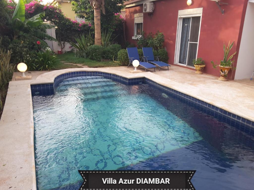 a swimming pool in the backyard of a house at Villa Azur in Saly Portudal
