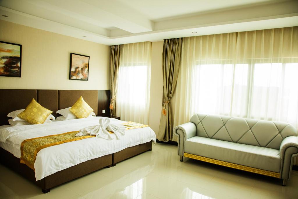 Jing Pin Hotel tesisinde bir odada yatak veya yataklar